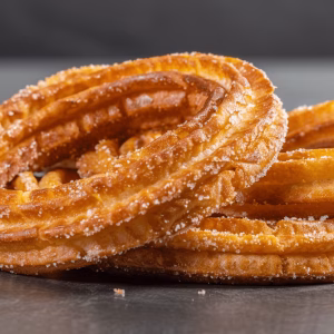 Spanish Style Circular Churros a table covered in sugar